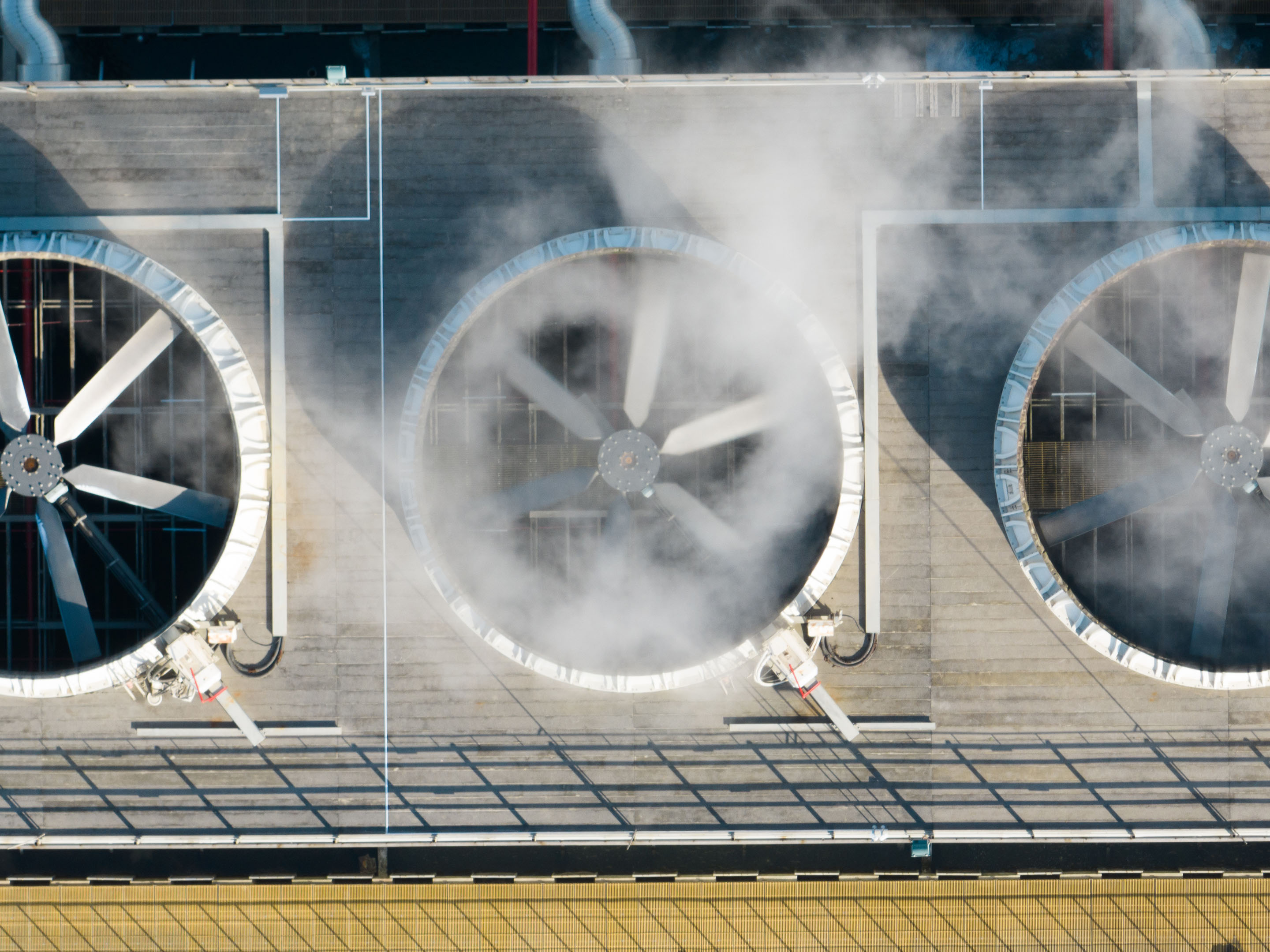 hon-cooling-tower-fans-steam-aerial-industrial-rooftop-1452684032.jpg