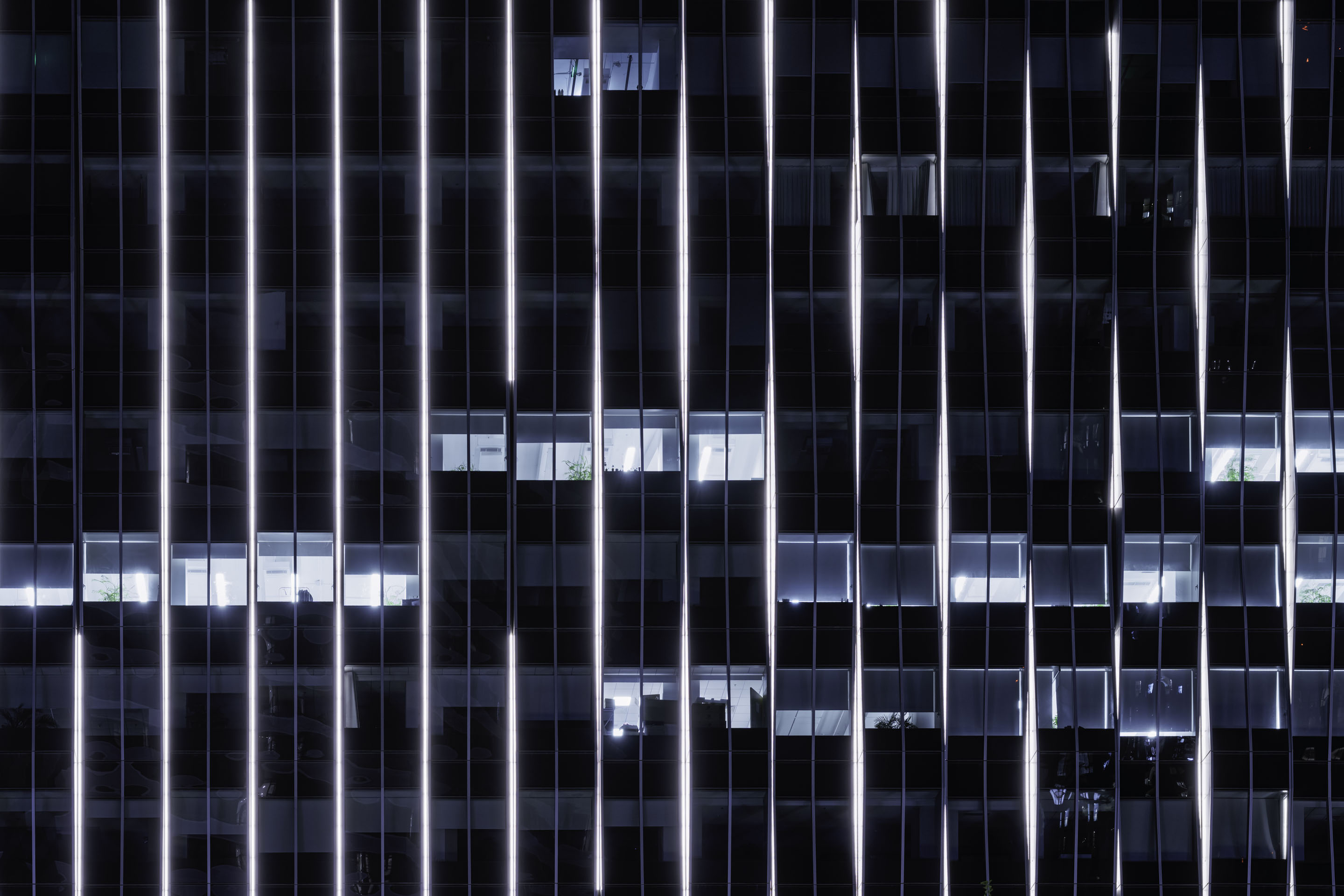 hon-glass-skyscraper-facade-led-lighting-night-2227987684.jpg