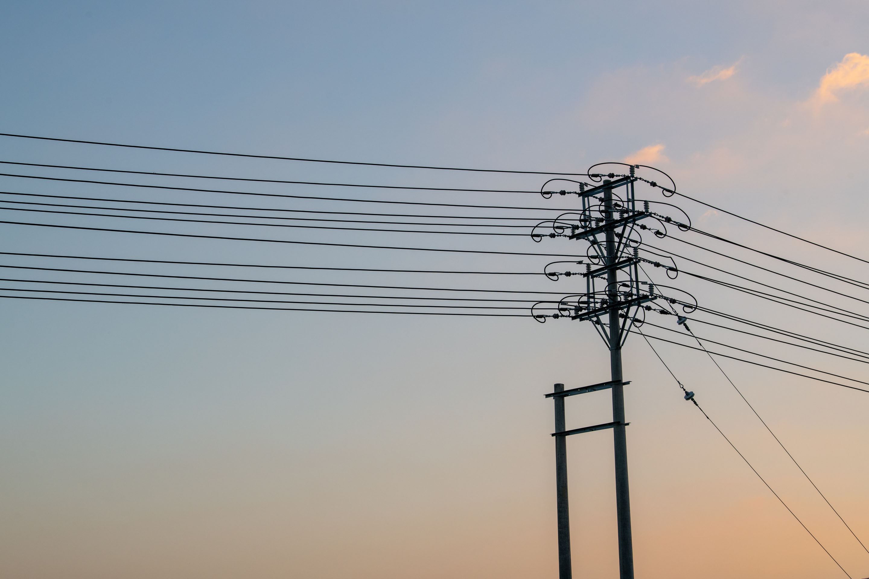 hon-electricity-distribution-pole-power-lines-dusk-1282442146.jpg