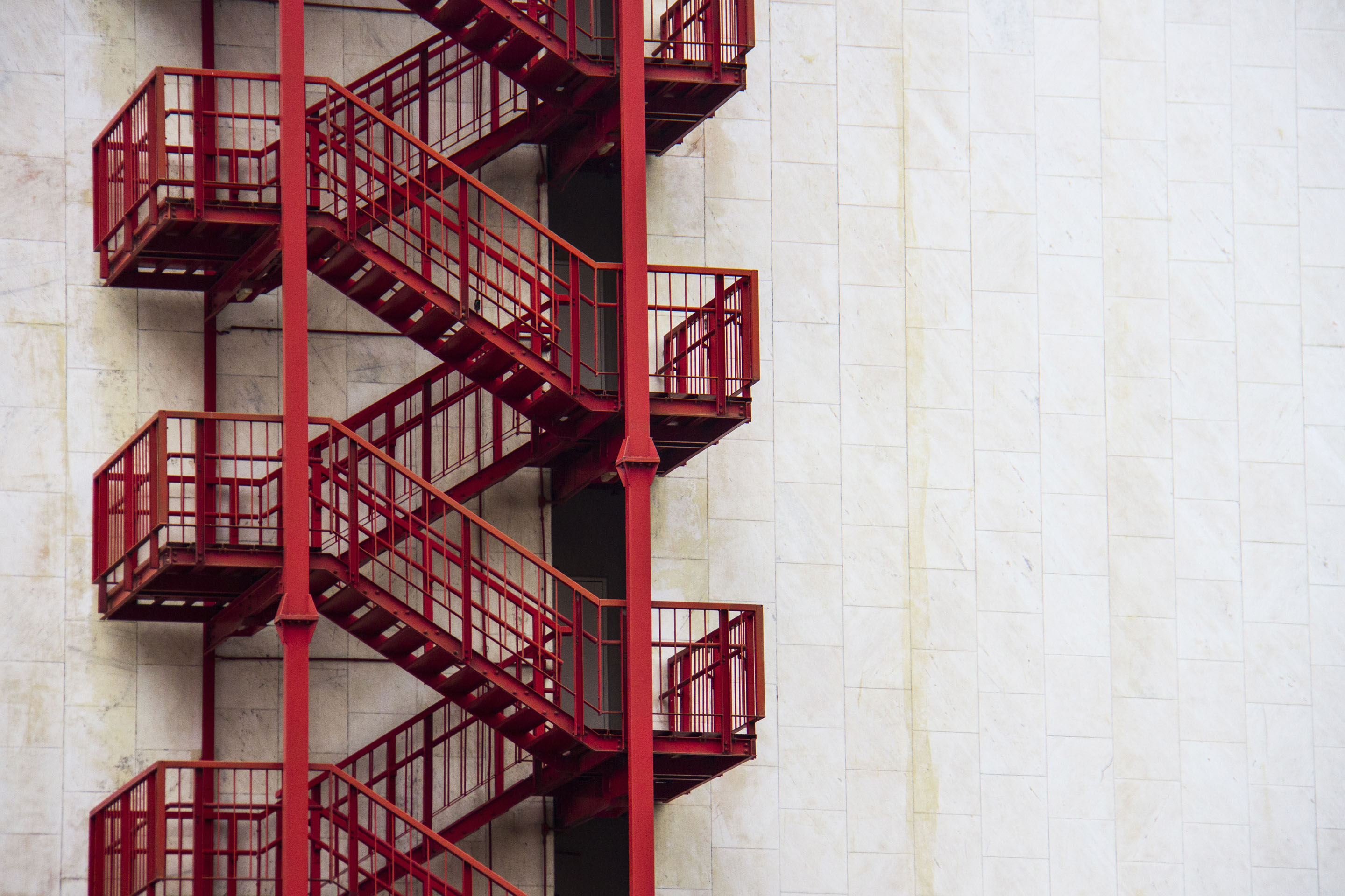 hon-red-external-fire-escape-staircase-white-building-1143338962.jpg
